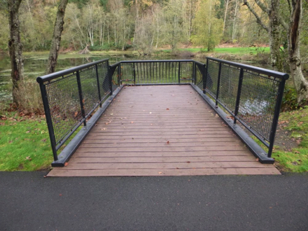 Overlook with railing at pond – transition from hard surface to wood at overlook